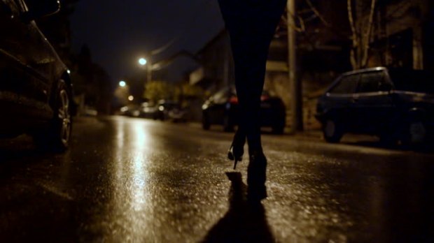 Low angle view point of female legs walking in the dark.